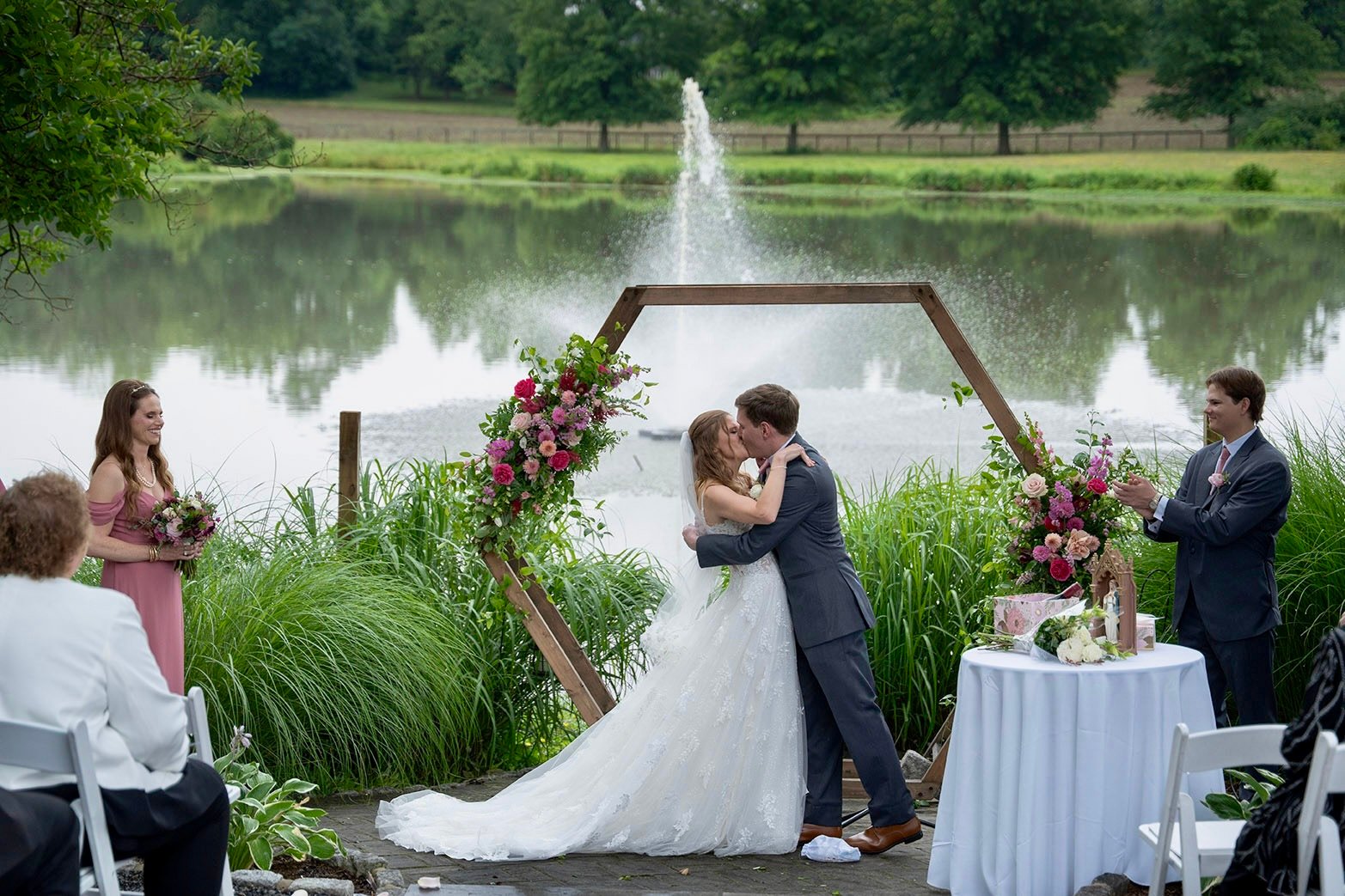 First kiss as husband and wife by lakeside ceremony at Estate at Eagle Lake